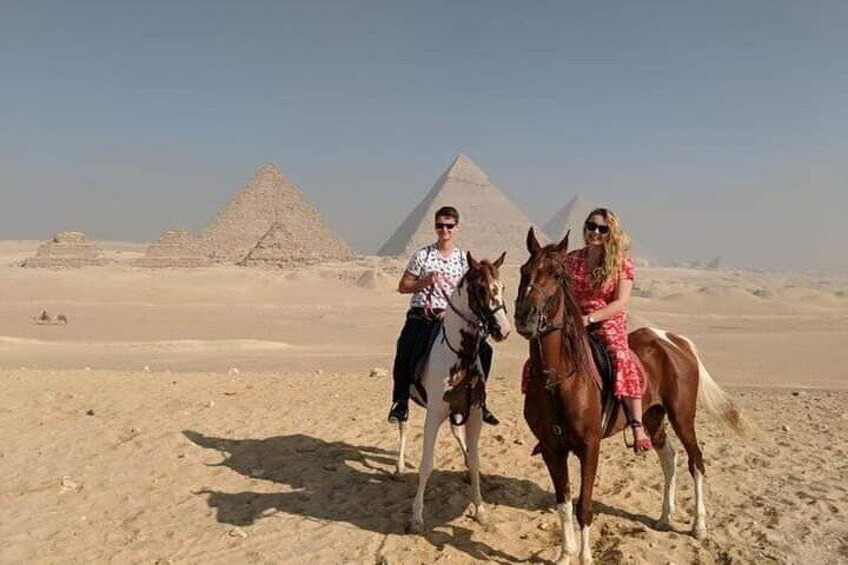 
Riding horses at the pyramids